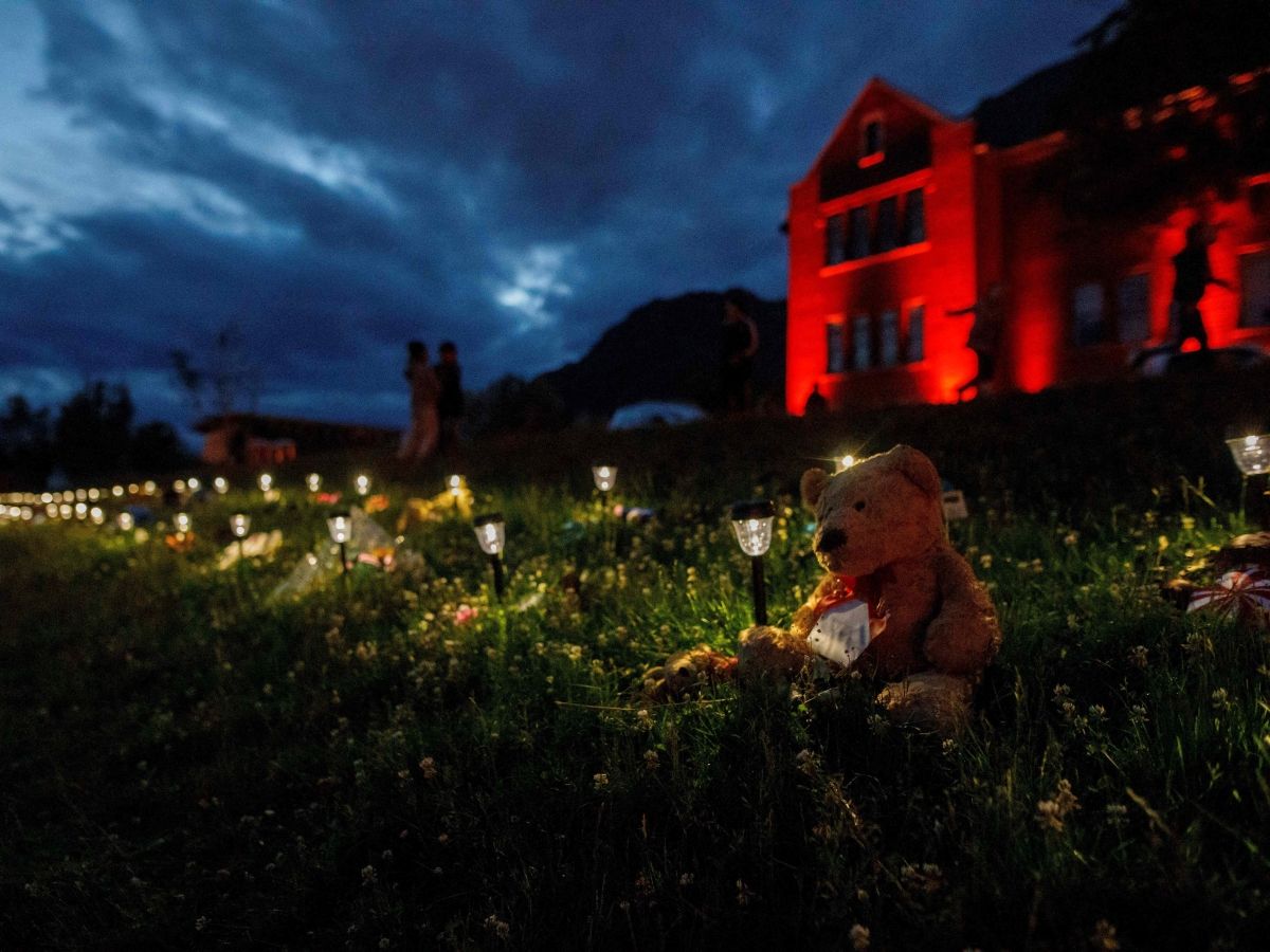 Teddy bear sits outside a former Kamloops Indian Residential School.