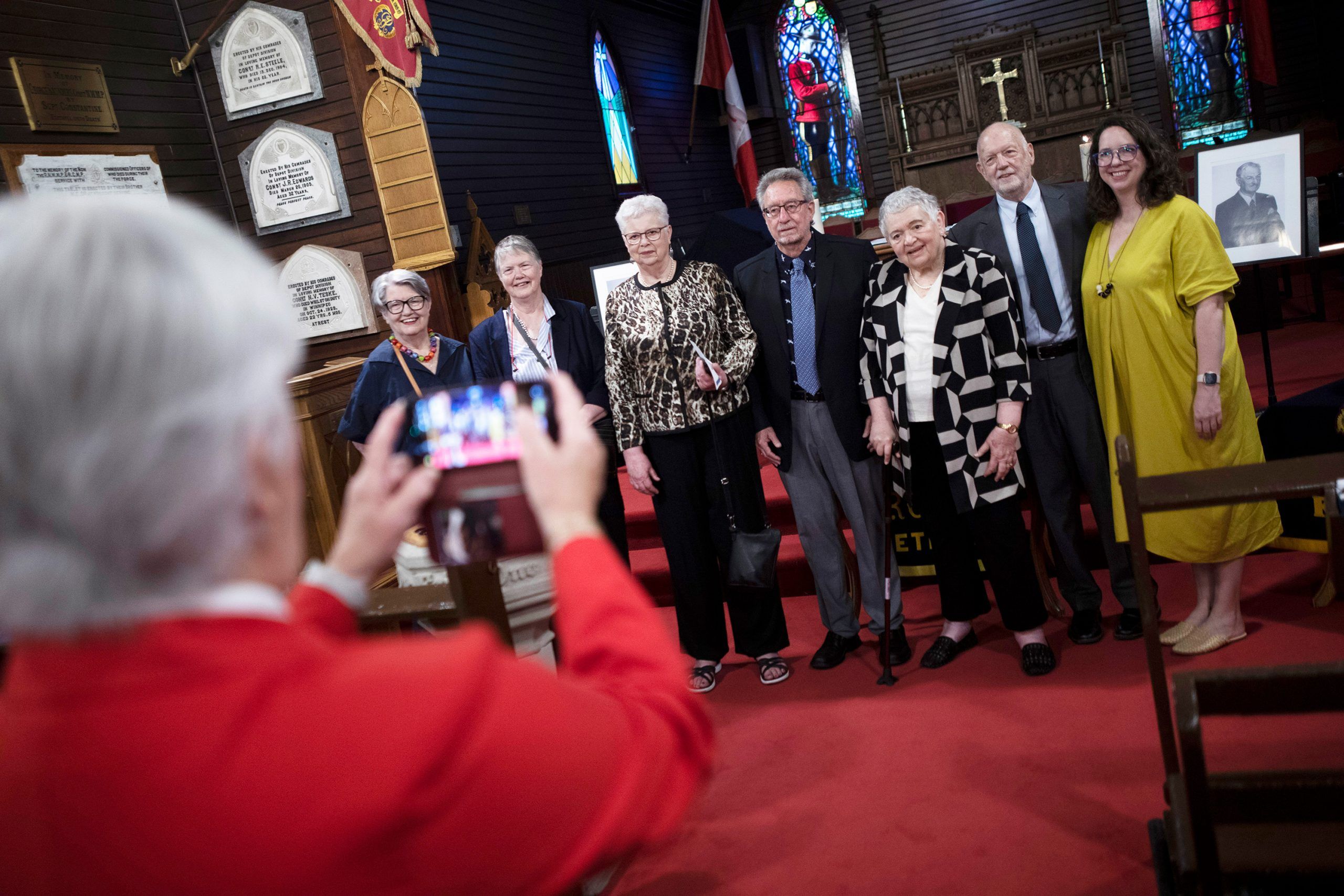 From left, Joe Atherton’s nieces, Nancy Miller and Pat Sanagan; his niece by marriage Janan Carr and her husband, Terry; his niece by marriage Jacquie Stinson; and his nephew, writer Tony Atherton, and Tony’s daughter, Emily. The group are having their photo taken in a church.