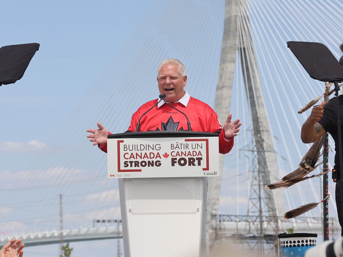 Doug Ford in front of a bridge.