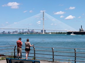 People fishing and a bridge.