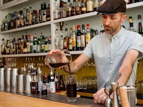 A bartender mixes cocktails.