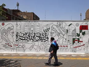 Man in front of a mural.