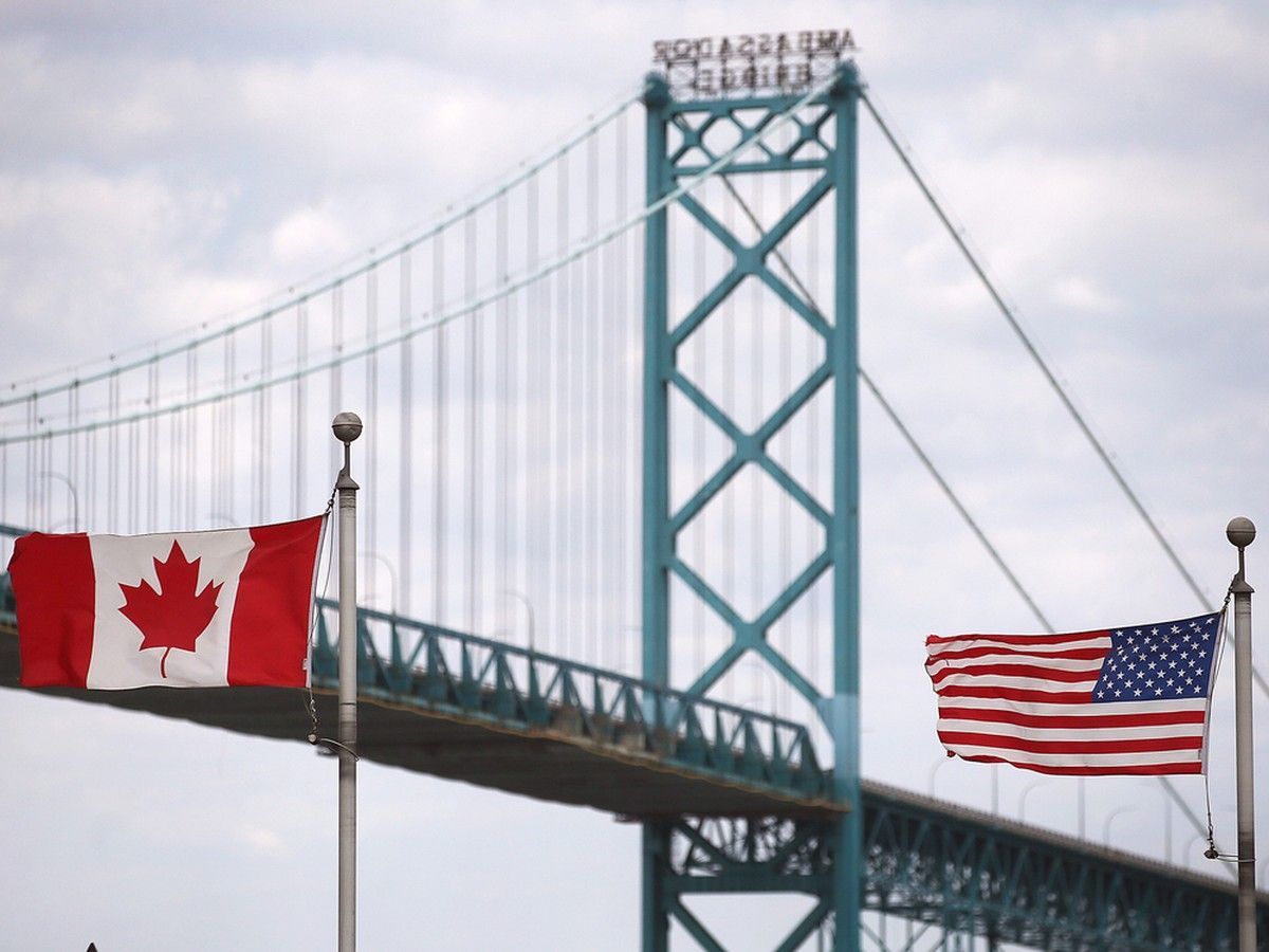 A Canadian and American flag are shown near the Ambassador Bridge in Windsor on Wednesday, March 12, 2025. A Canadian and American flag are shown near the Ambassador Bridge in Windsor on Wednesday, March 12, 2025.