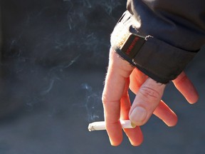 A cigarette in someone's hand.