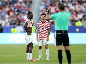 Folarin Balogun, left, and Christian Pulisic of the United States reacts to