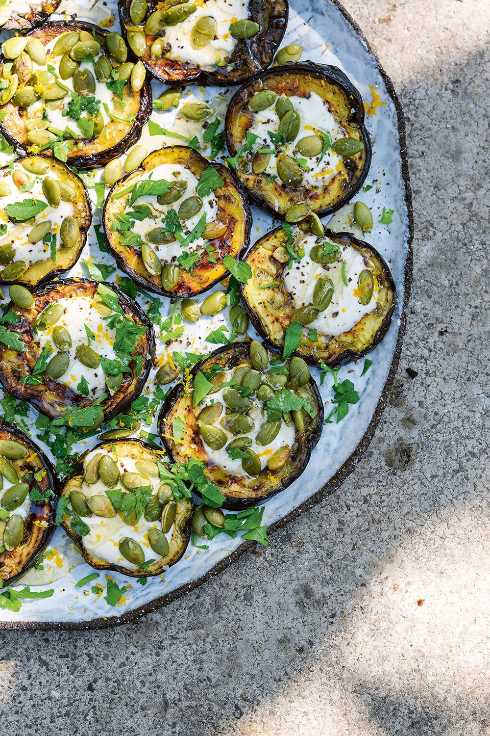 Grilled eggplant with whipped goat's cheese, orange zest and pumpkin seeds