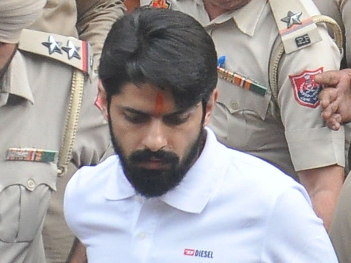 Lawrence Bishnoi surrounded by police security while coming out of the Amritsar court complex in India on Oct.31, 2022.