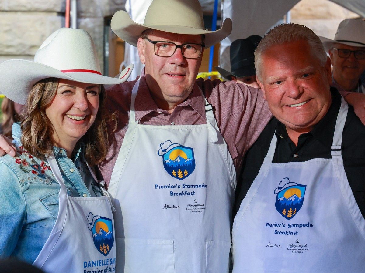 A trio of premiers, Alberta Premier Danielle Smith, Saskatchewan Premier Scott Moe and Ontario Premier Doug Ford pose for a photo while working in the serving line at the annual Premier’s Stampede Breakfast at McDougall Centre in Calgary on Monday, July 7, 2025. A trio of premiers, Alberta Premier Danielle Smith, Saskatchewan Premier Scott Moe and Ontario Premier Doug Ford pose for a photo while working in the serving line at the annual Premier’s Stampede Breakfast at McDougall Centre in Calgary on Monday, July 7, 2025.