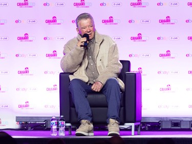 William Shatner speaks into a microphone while sitting in an armchair on a stage at the Calgary Comic and Entertainment Expo at the BMO Centre in April 2026.