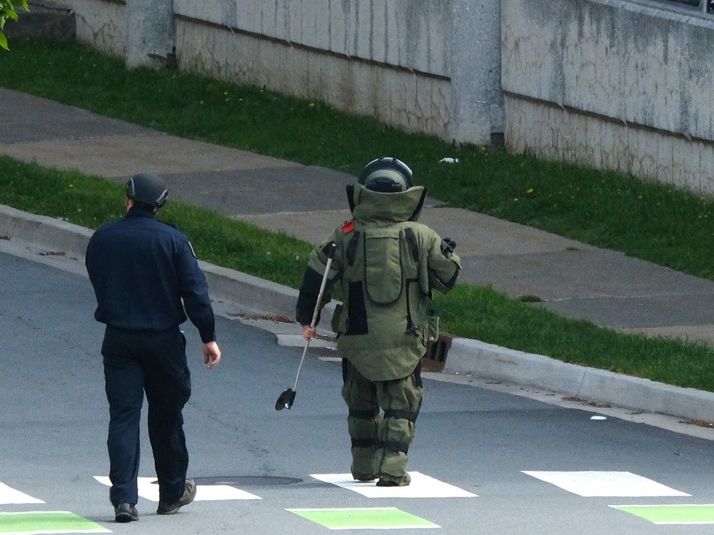  A member of the Halifax Regional Police bomb disposal unit walks towards a parkade during a bomb threat investigation in Halifax on Monday, Aug. 10, 2026.
