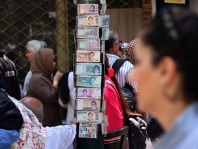 People walk past shops att the Grand Bazaar in Tehran on August 1, 2026. Iran's military accused the United States of