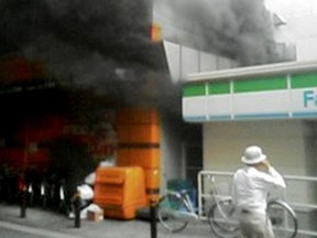 Smoke rises from a fire at a slot machine parlor in Osaka
