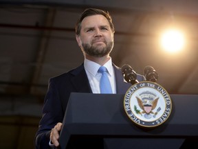 JD Vance pictured behind a lectern.