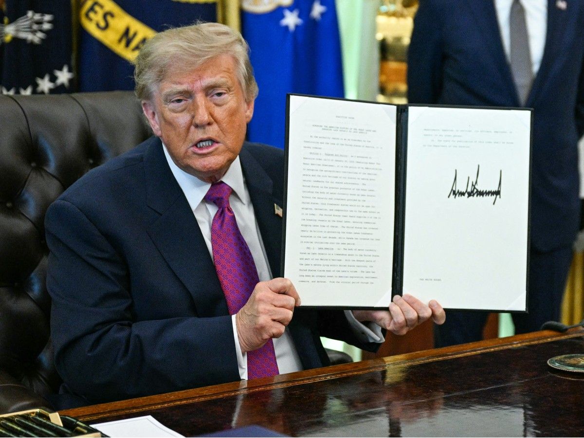 Donald Trump in the Oval Office with a signed order to change Lake Ontario to Lake America.