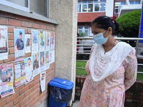 A woman looks at photographs of the missing