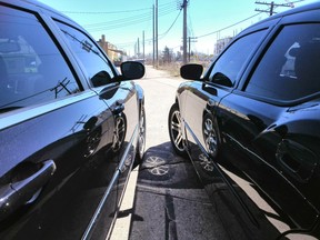 A 2009 Chrysler 300 on the left and 2006 Dodge Charger R/T on the right with tinted windows.