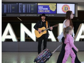 Music star Paul Brandt with his guitar at Calgary airport.