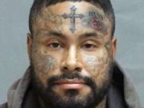 mugshot of a man with tattoos on his face