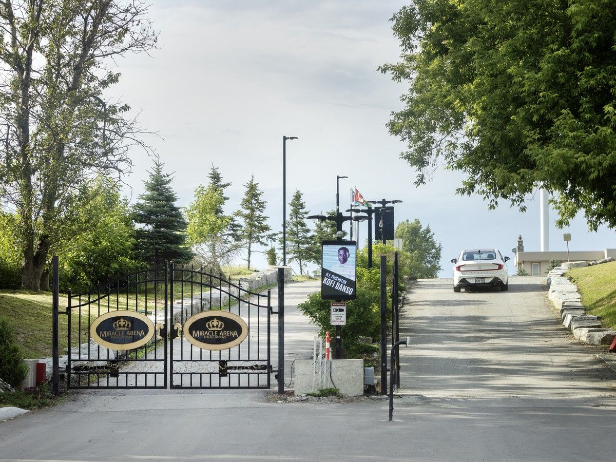  A car passes through an entrance gate to the Miracle Arena church in June, 2026.