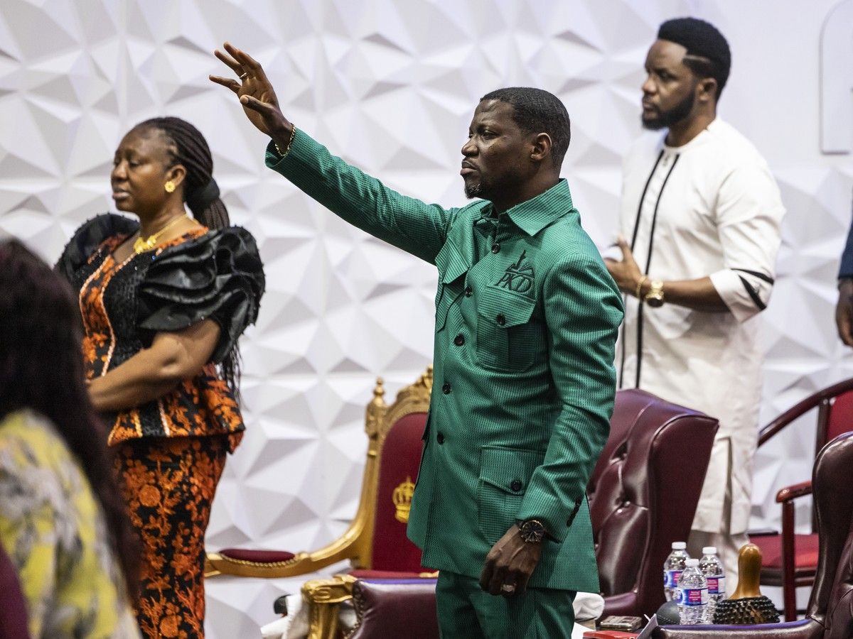  Pastor Kofi Danso (centre, in green) prays during a service by another minister at the Miracle Arena For All Nations church in Vaughan in April, 2024.