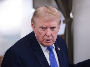 A close up of U.S. President Donald Trump wearing a suit with a blue tie.