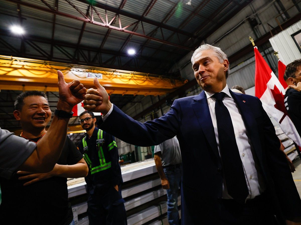 Finance Minister François-Philippe Champagne gives a thumbs up to a worker after a press conference at Ideal Roofing Company Limited Manufacturers in Ottawa on Tuesday, Aug. 25, 2026. Finance Minister François-Philippe Champagne gives a thumbs up to a worker after a press conference at Ideal Roofing Company Limited Manufacturers in Ottawa on Tuesday, Aug. 25, 2026.