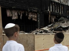 jewish boys looking at burned out building