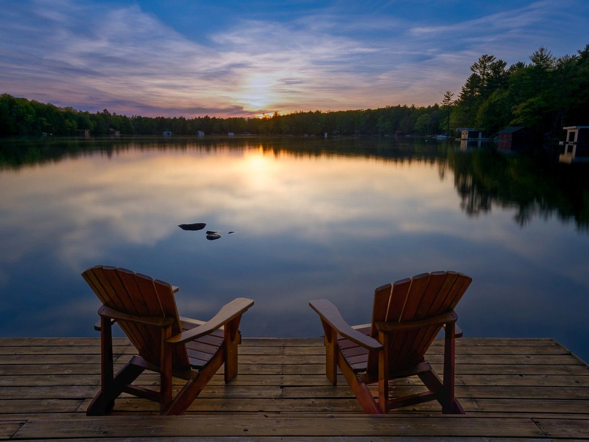 Muskoka chairs at a lake
