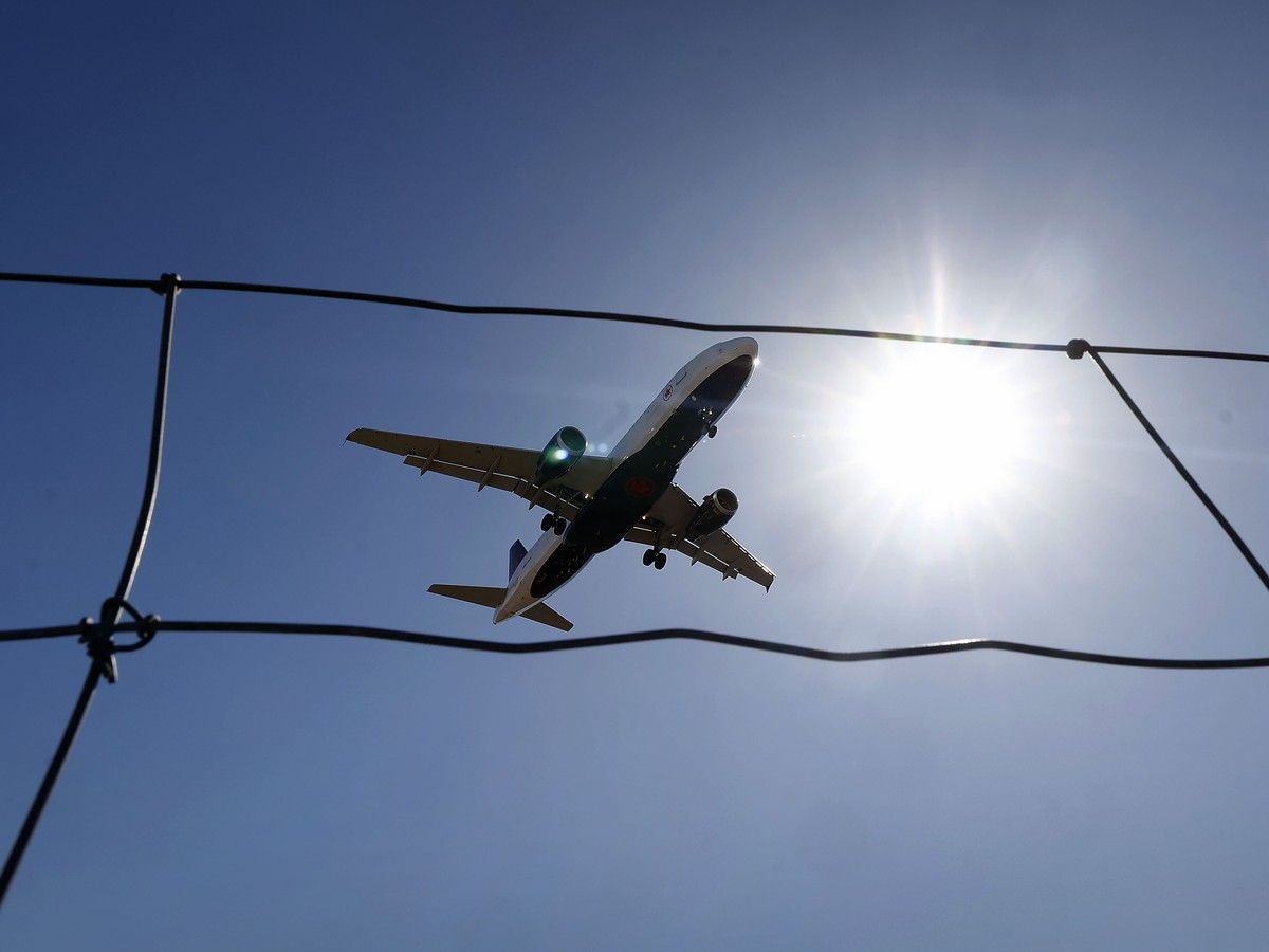 A plane picture from below with a blue sky in the background.