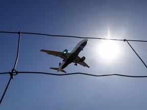 A plane picture from below with a blue sky in the background.