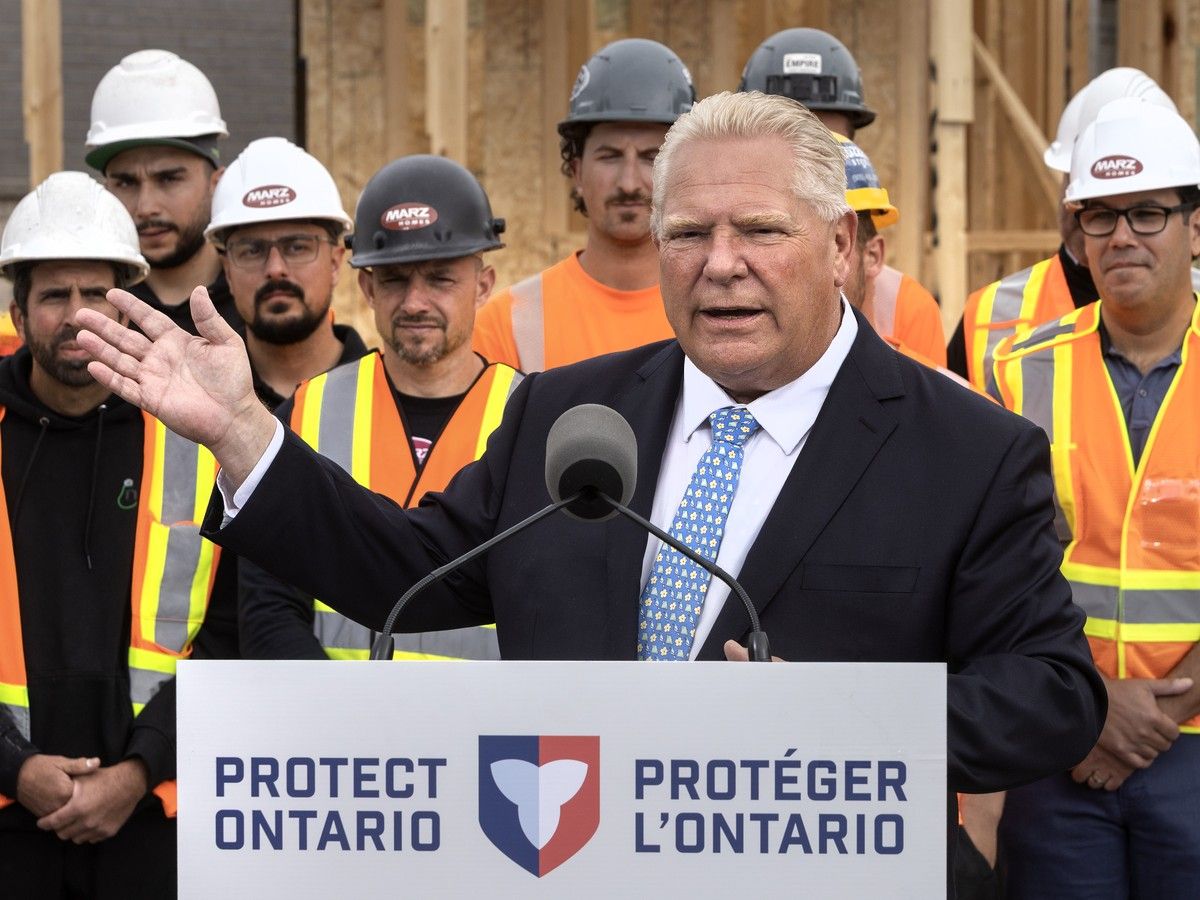 Doug Ford speaking at podium, trades workers behind him