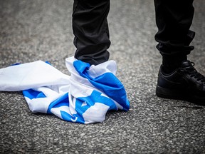 A foot stomping on an Israeli flag.