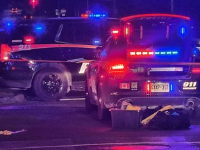 Police cars on a street at night.