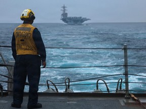 A U.S. Navy sailor standing on the flight