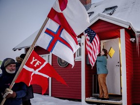 A protester holds flag outside the U.S. consulate in Nuuk,