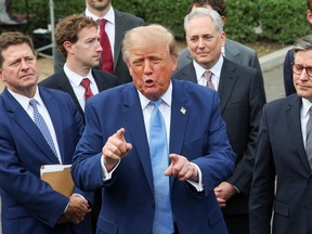 Donald Trump makes a speech while he stands with tech CEOs