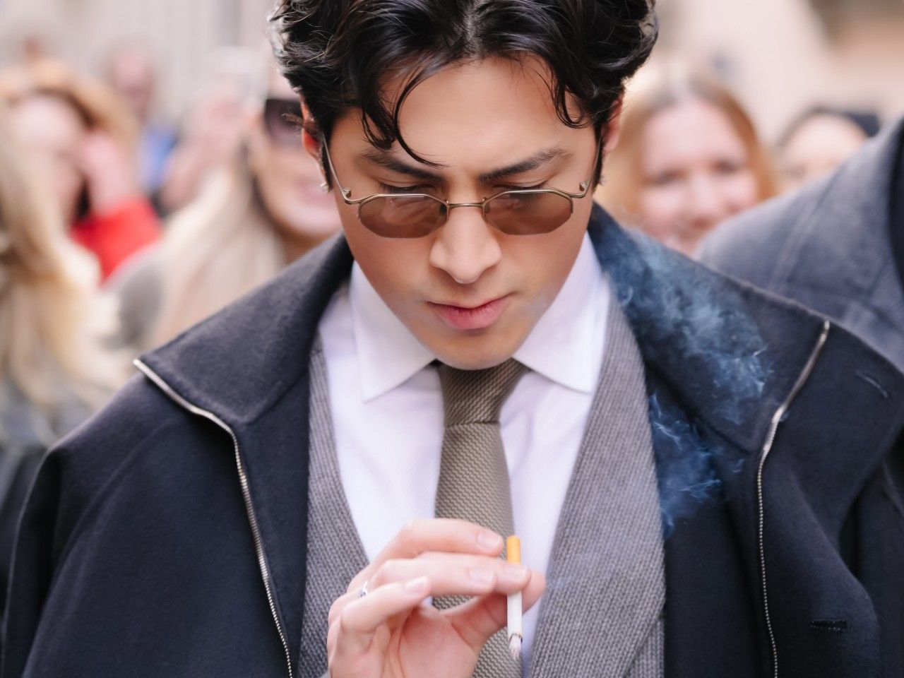 Heated Rivalry star Hudson Williams smokes a cigarette in Milan.