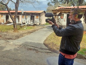 Igal Hecht at a destroyed kibbutz.