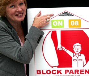 Woman points to new Block Parent sign.