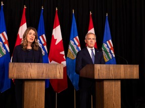 Prime Minister Mark Carney and Alberta Premier Danielle Smith speak in Calgary on Friday, May 15, 2026 before signing an agreement on oil pipeline approvals and carbon pricing.