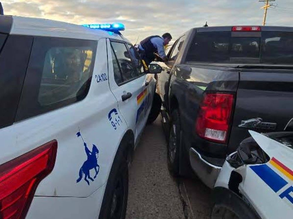 The RCMP used multiple vehicles to stop an armed man in a truck who fled the border crossing in Emerson, Man.
