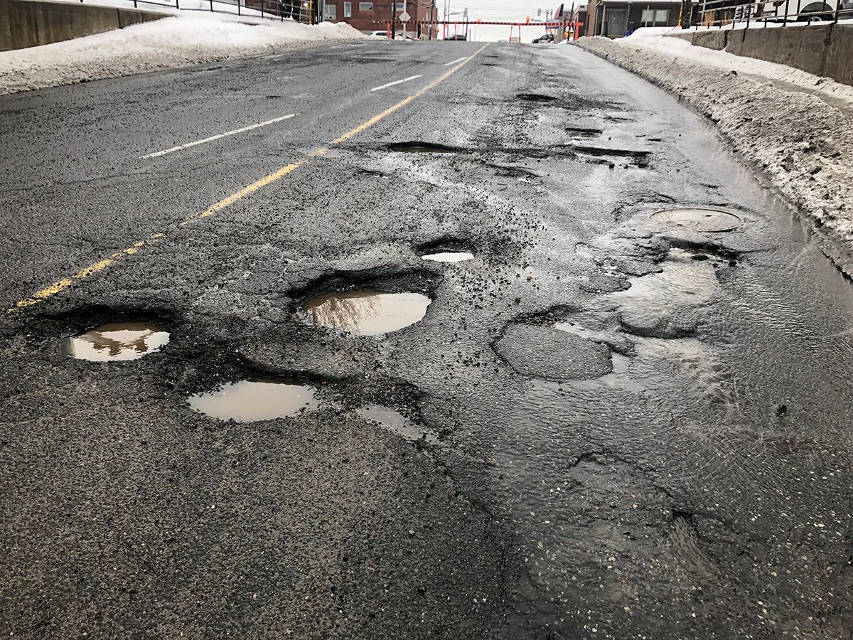 Potholes in a road.