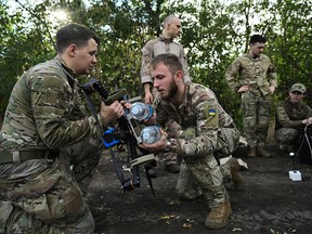 Ukrainian servicemen prepare a FPV drone for a training flight.