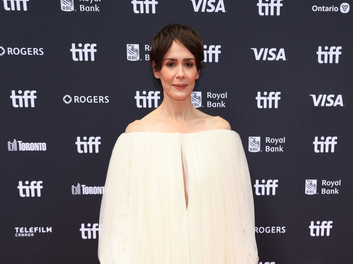 Sarah Paulson wearing a white dress on the red carpet at TIFF.