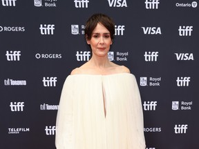 Sarah Paulson wearing a white dress on the red carpet at TIFF.