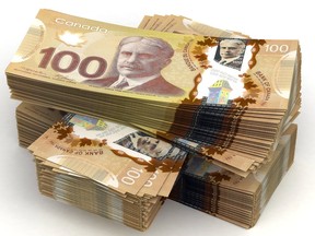 Bundles of Canadian bills against a white background