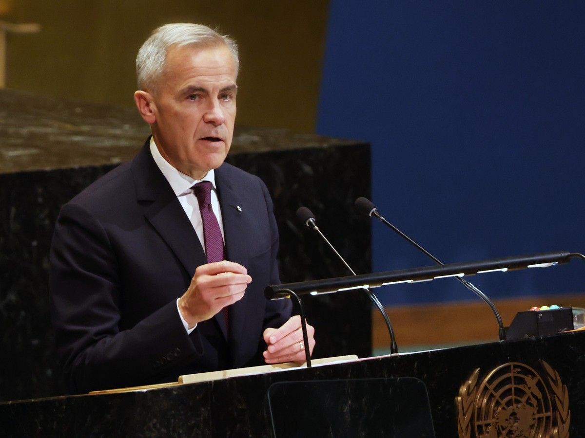 Mark Carney speaks from behind a lectern.
