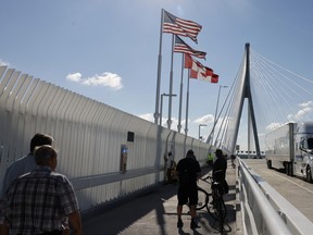 people walking on a bridge