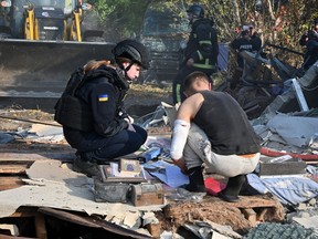 A local resident searches for documents in the ruins