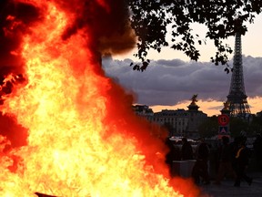 A fire is seen with the Eiffel Tower in the background